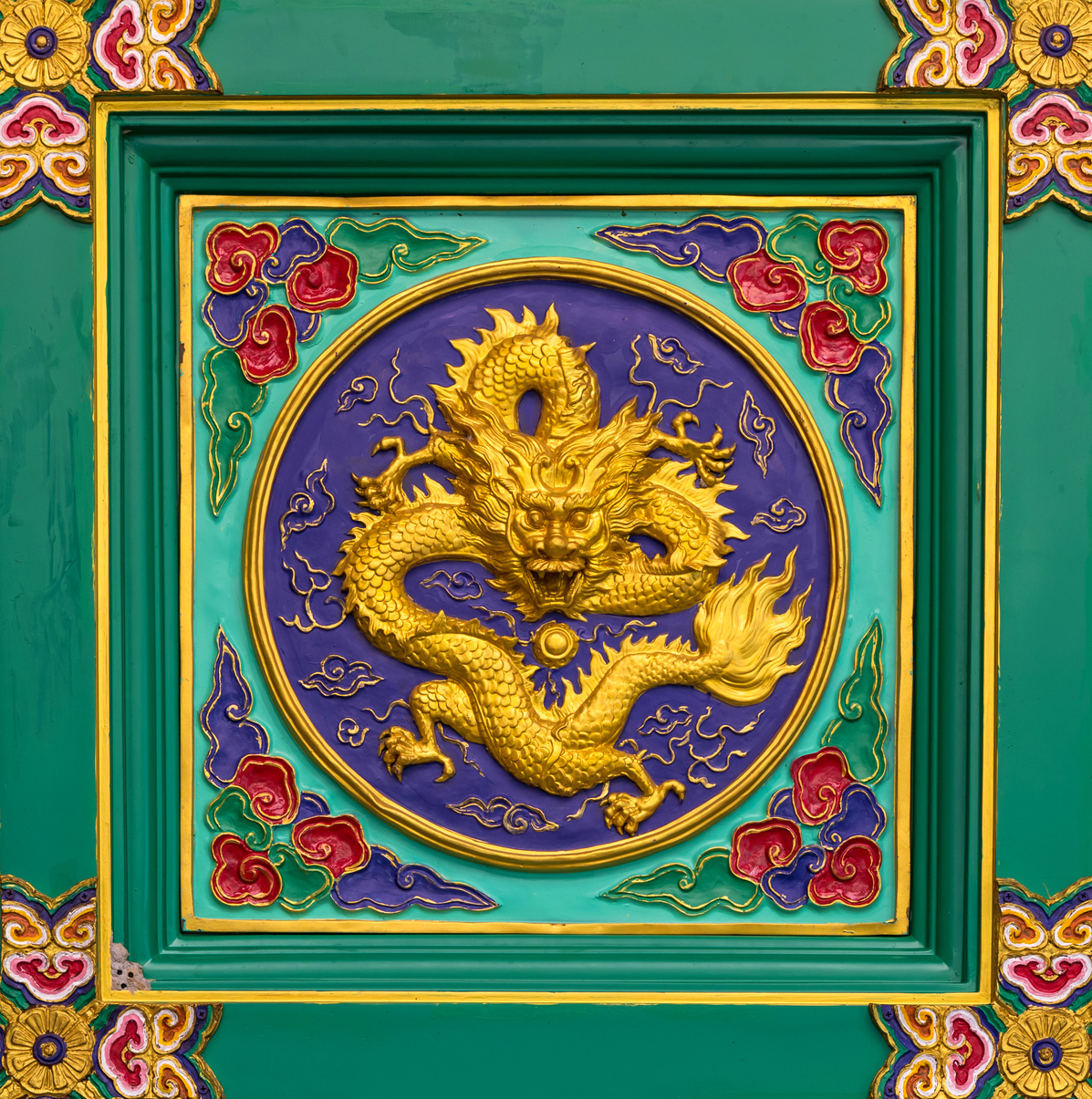 gold dragon statue on chinese temple wall,Thailand.